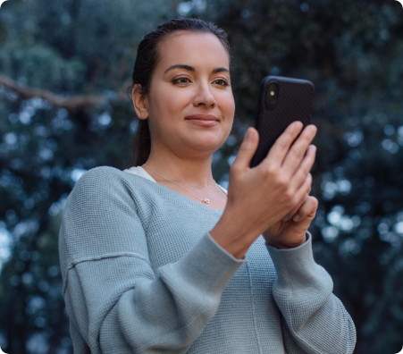 person unlocking front door with phone